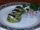 Infornata di sardelle e patate profumate con aglio prezzemolo e vino bianco su salsa verde;